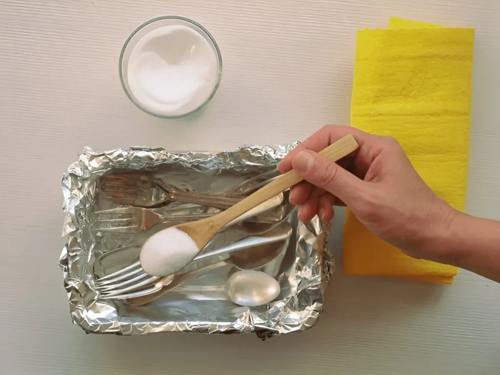 Demonstration on how to clean silverware with baking soda and aluminium foil