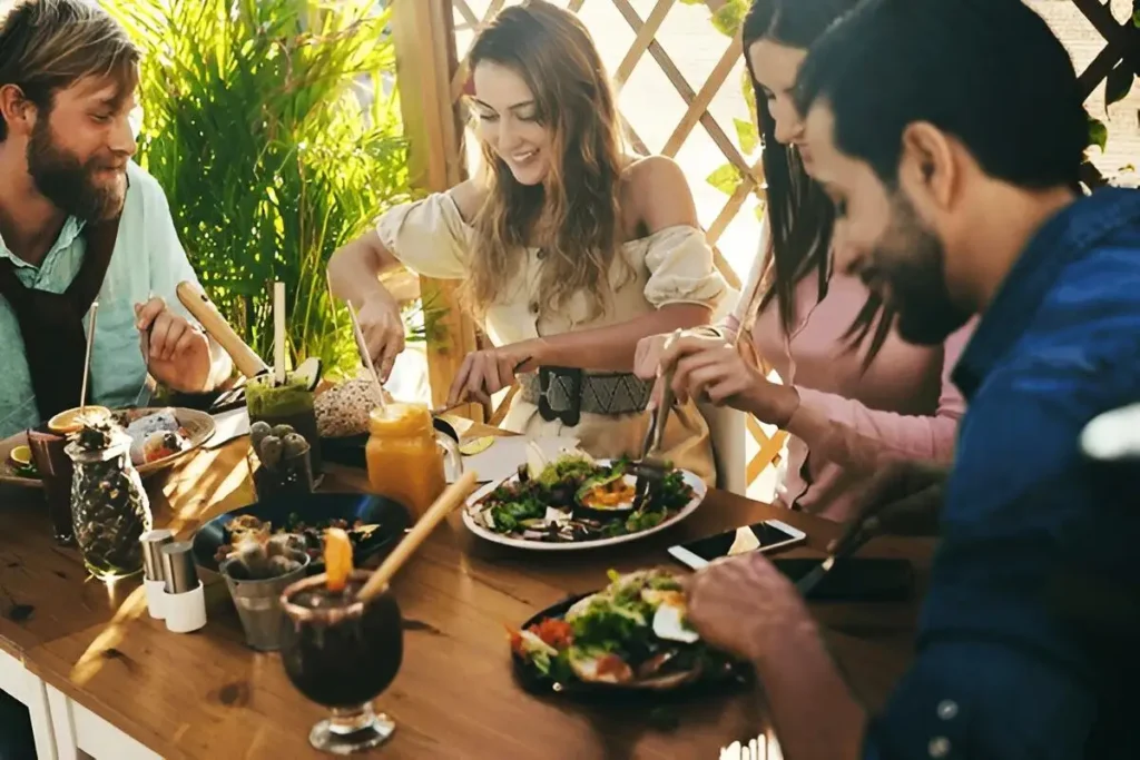 4 young people having a lunch on a terrace using Sabre Bistrot cutlery