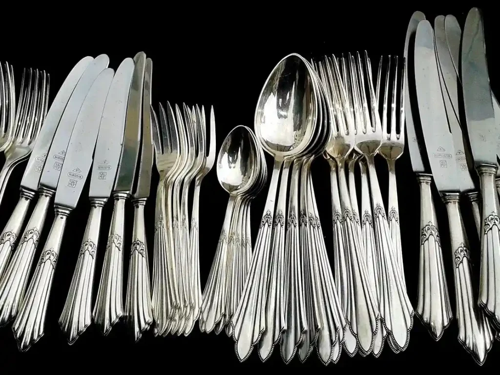 A collection of stainless steel forks, spoons and knives