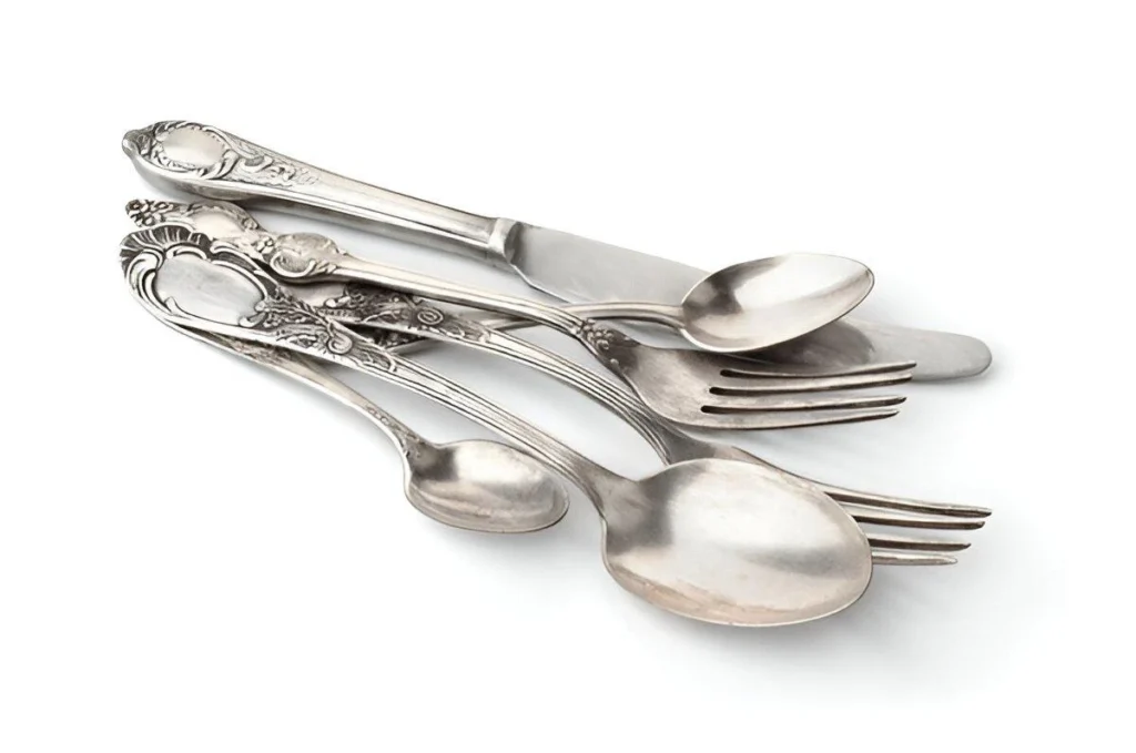 A sterling silver flatware set on a white background