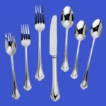 A 7 piece Lenox silverware set on a blue background
