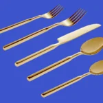 A Godinger silverware Cubit five‑piece place setting on blue background