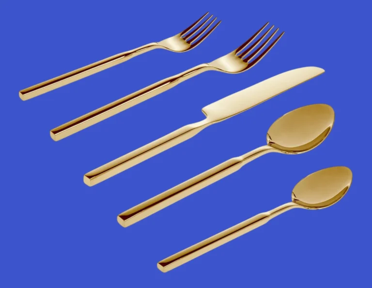 A Godinger silverware Cubit five‑piece place setting on blue background