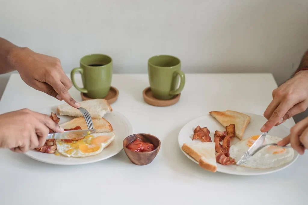 A couple using Sambonet silverware in having breakfast