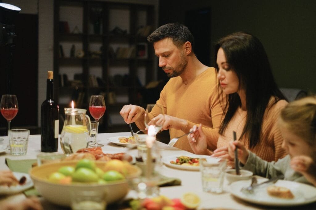 A family using the Nambe aura flatware on a dining table
