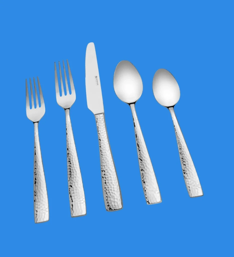 A 5 piece place setting of Hudson Essentials hammered silverware