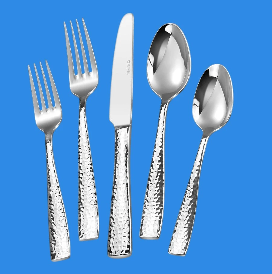A 5 piece place setting of KEAWELL Premium Louis hammered silverware