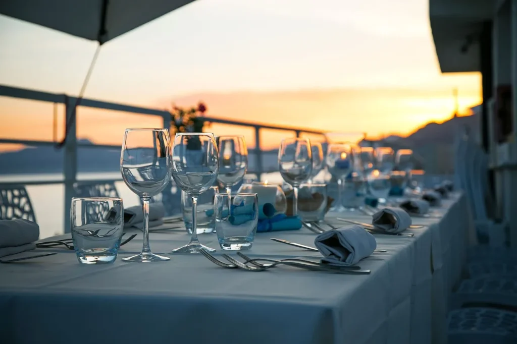 A dining table set for a formal dinner on a terrace
