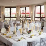 A banquet room full of tables to demonstrate how to use silverware