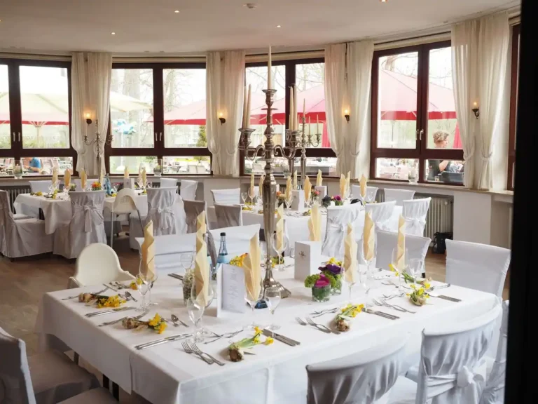 A banquet room full of tables to demonstrate how to use silverware