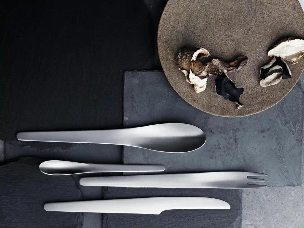 Georg Jensen silverware's Arne Jacobsen place setting arranged on a minimalist Scandinavian dining table